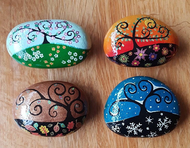 hand painted trees in different seasons stones